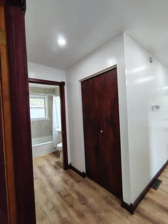 an empty room with closet and a bathroom