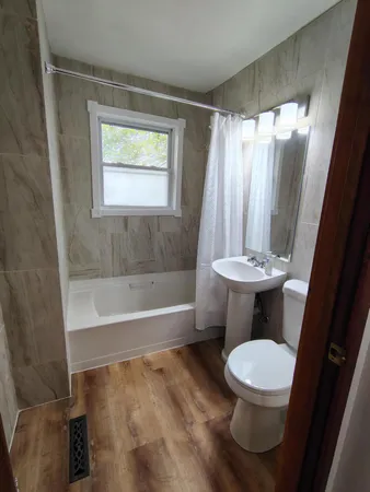 a bathroom with a toilet a sink and a bathtub