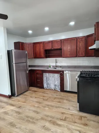 a kitchen with stainless steel appliances granite countertop a refrigerator sink and cabinets