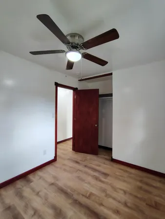 a view of an empty room and wooden floor