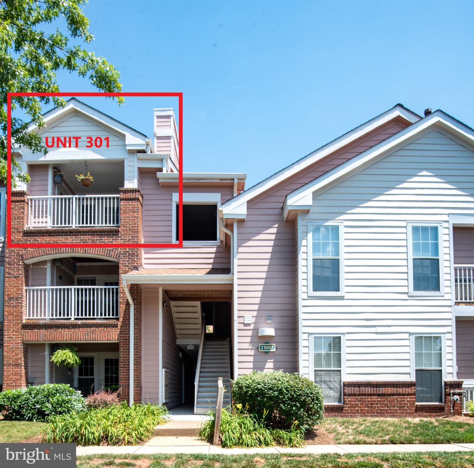 21007 Timber Ridge Terrace, Unit 301 Ashburn, VA 20147 - Photo 2 of 30 Photo shows Unit 301 with balcony and chimney