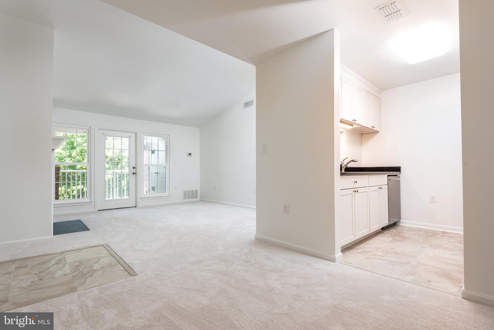 21007 Timber Ridge Terrace, Unit 301 Ashburn, VA 20147 - Photo 11 of 30 View from dining room into kitchen and living room
