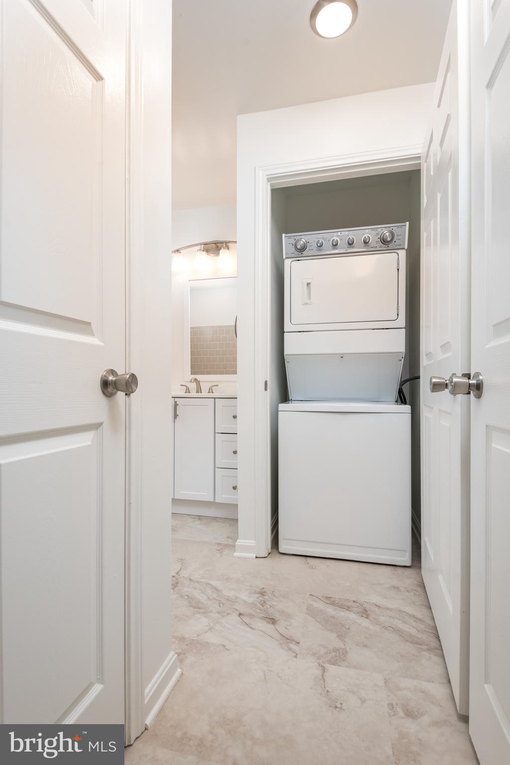 21007 Timber Ridge Terrace, Unit 301 Ashburn, VA 20147 - Photo 21 of 30 Stacked washer/dryer in laundry closet in bathroom