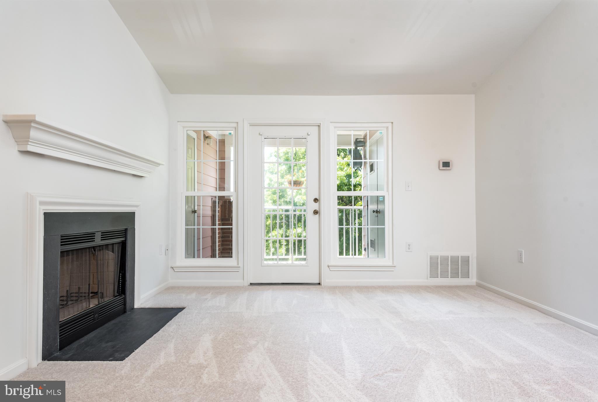21007 Timber Ridge Terrace, Unit 301 Ashburn, VA 20147 - Photo 7 of 30 Living room with access to private balcony