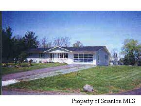 8279 Griffin Road Moscow, PA 18444 - Photo 1 of 1 a view of a house with a yard