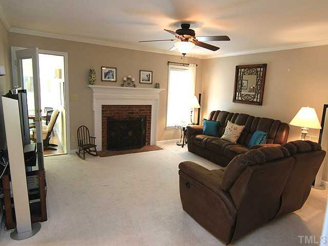 225 Glen Eden Road Durham, NC 27713 - Photo 3 of 18 Large living room features a cozy gas log fireplace, updated ceiling fan/light fixture and access to the enclosed sunroom.