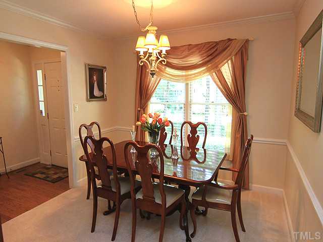 225 Glen Eden Road Durham, NC 27713 - Photo 5 of 18 The formal dining room features an updated light fixture, crown molding and chair rail.