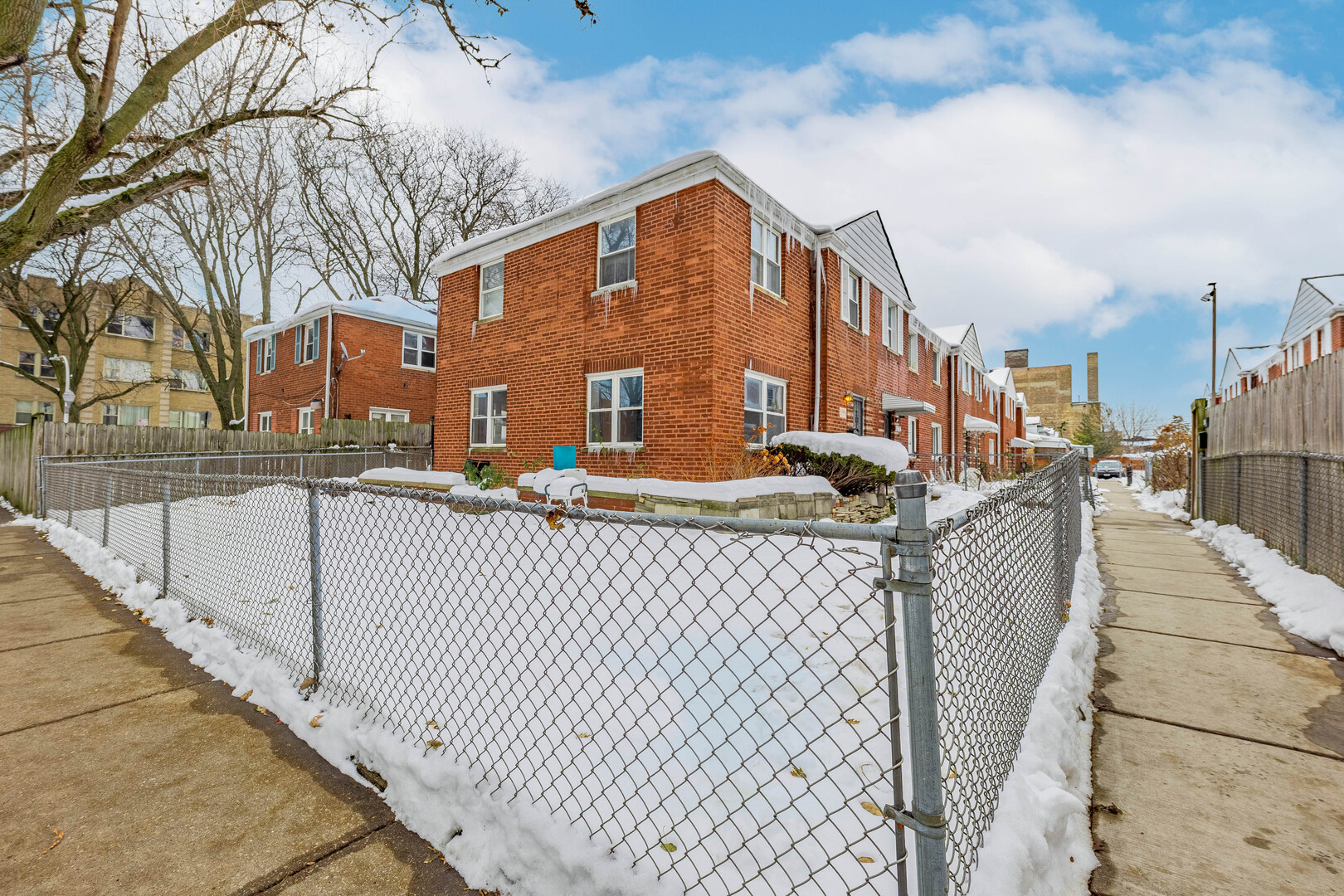 a view of a brick building next to a yard