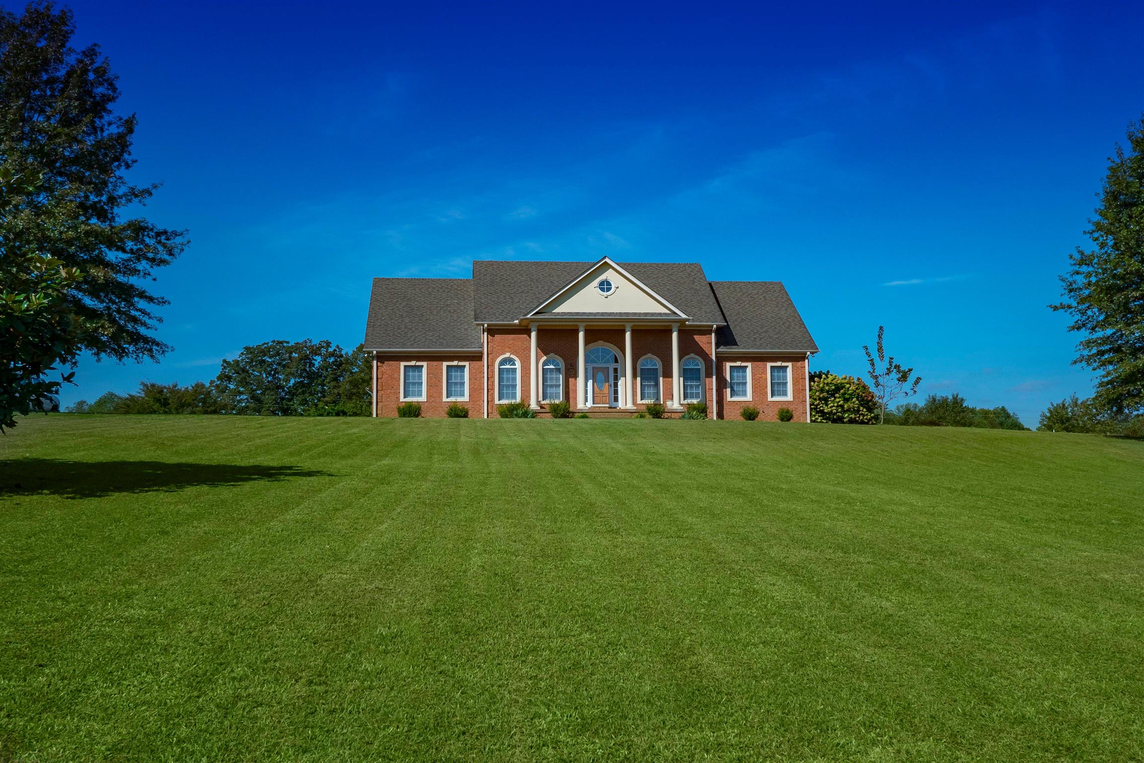 a front view of a house with a garden