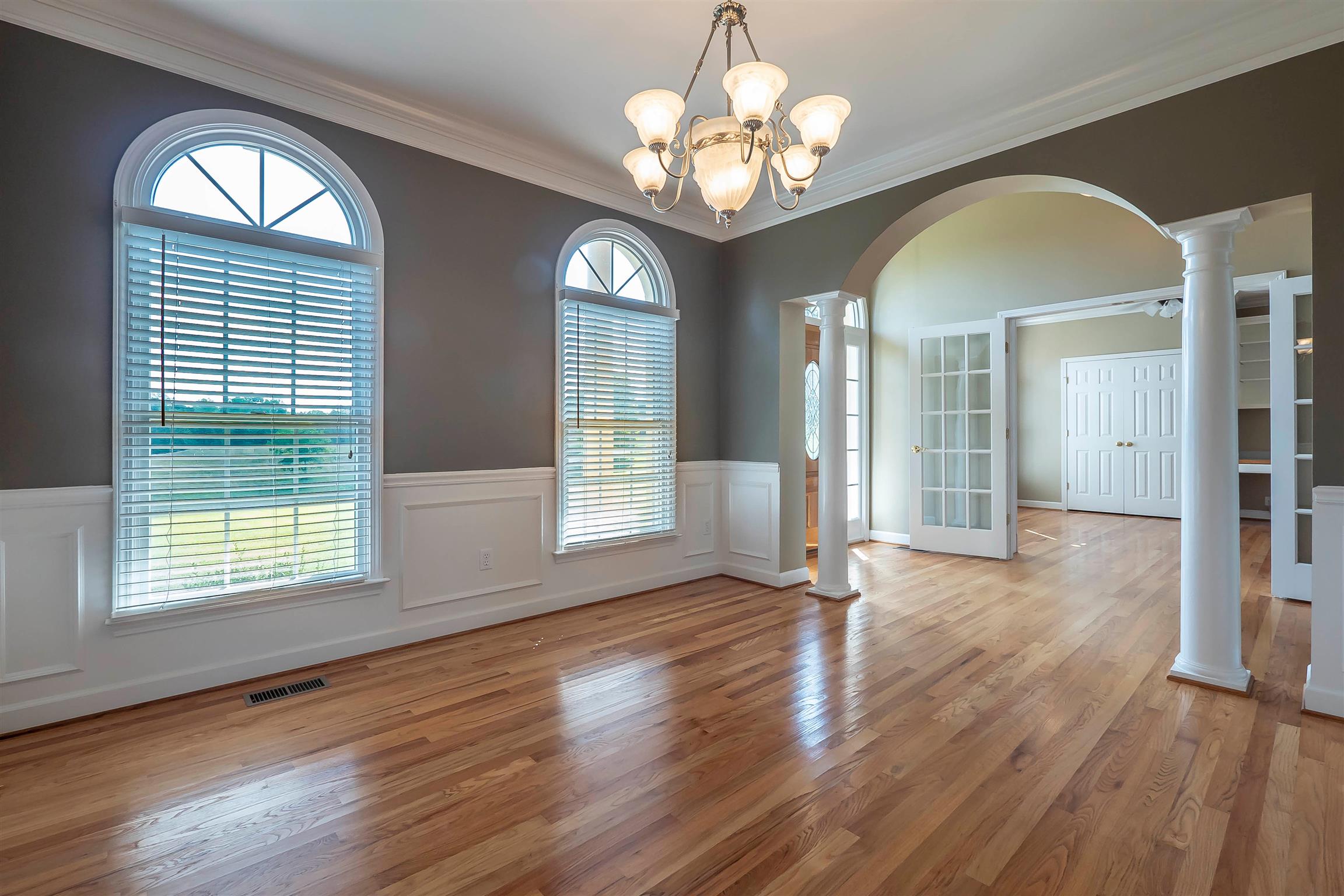 7722 Barnhill Road Primm Springs, TN 38476 - Photo 12 of 30 a view of an empty room with wooden floor and a window