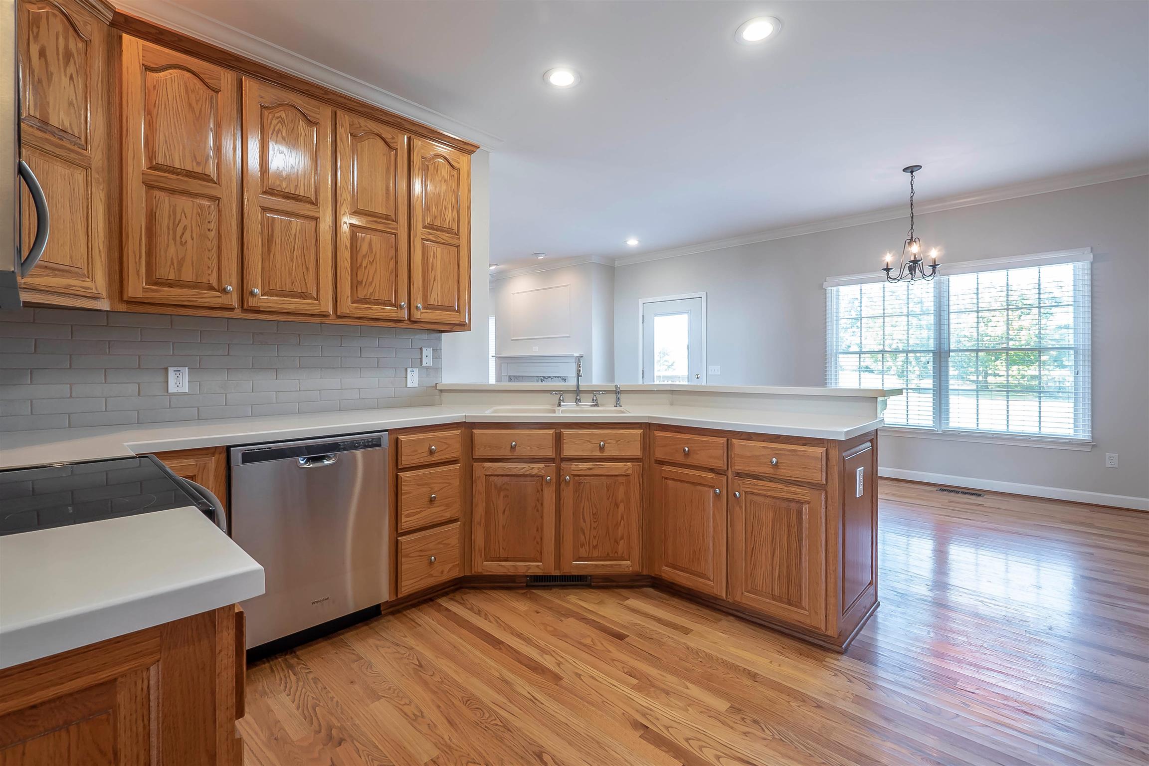 7722 Barnhill Road Primm Springs, TN 38476 - Photo 16 of 30 a kitchen with stainless steel appliances granite countertop wooden cabinets a sink and dishwasher with wooden floor