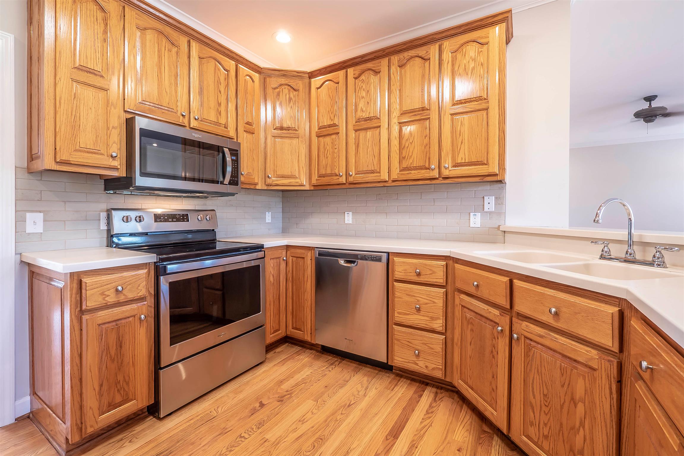 7722 Barnhill Road Primm Springs, TN 38476 - Photo 17 of 30 a kitchen with stainless steel appliances granite countertop a sink a stove and a microwave