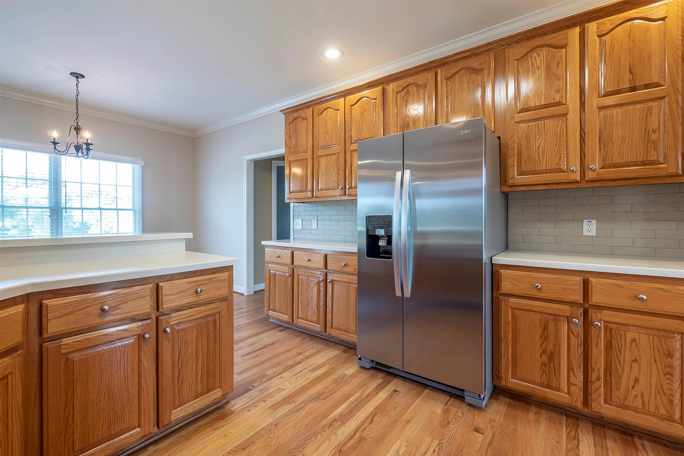 7722 Barnhill Road Primm Springs, TN 38476 - Photo 18 of 30 a kitchen with granite countertop stainless steel appliances a refrigerator and cabinets
