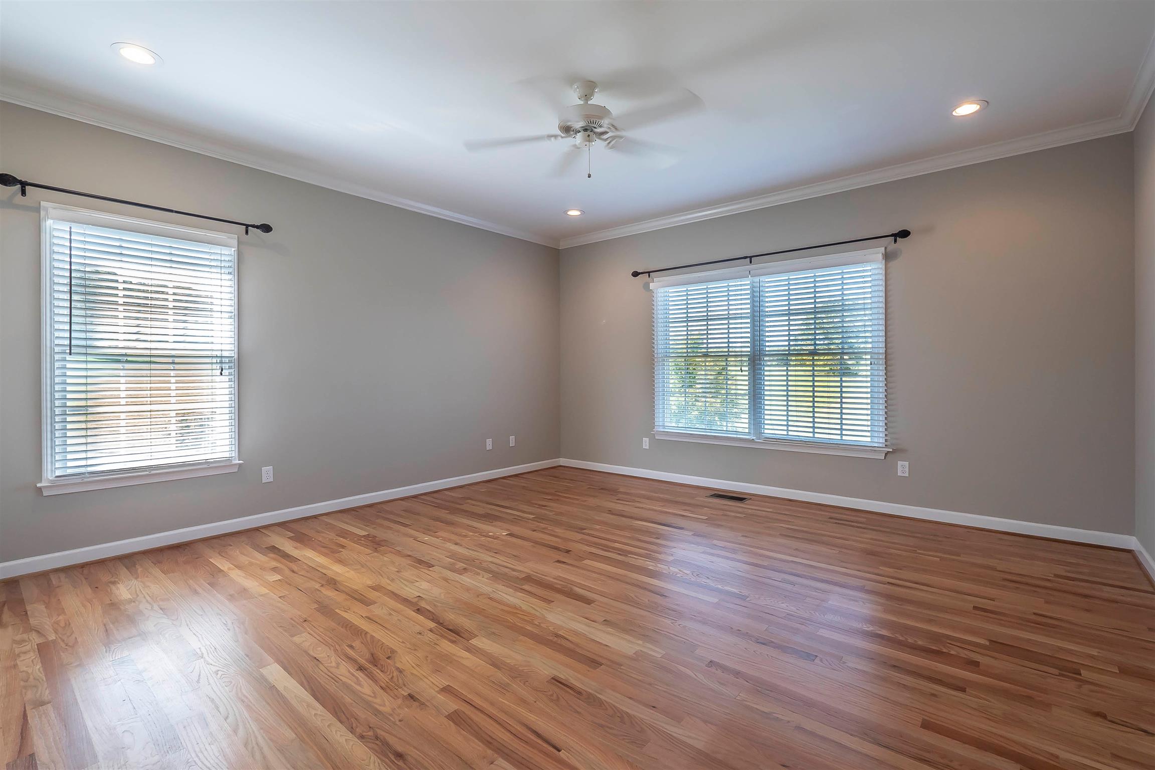 7722 Barnhill Road Primm Springs, TN 38476 - Photo 19 of 30 an empty room with wooden floor and windows