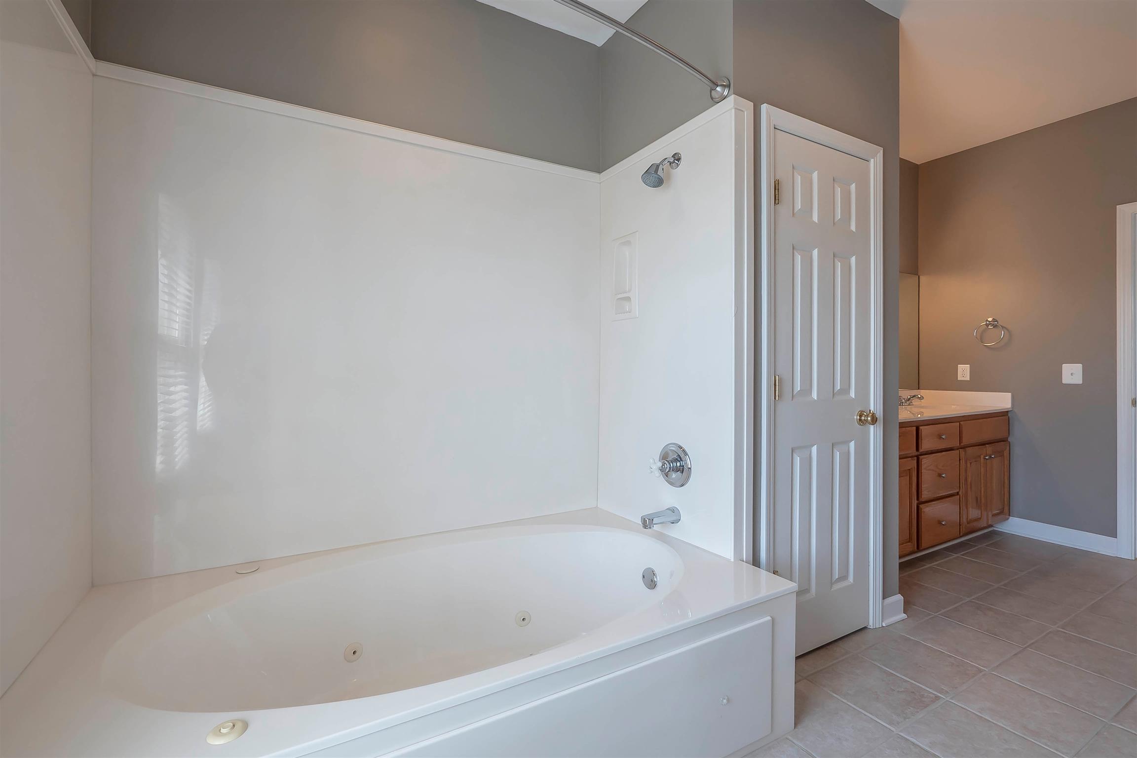 7722 Barnhill Road Primm Springs, TN 38476 - Photo 21 of 30 a bathroom with a bathtub and a shower