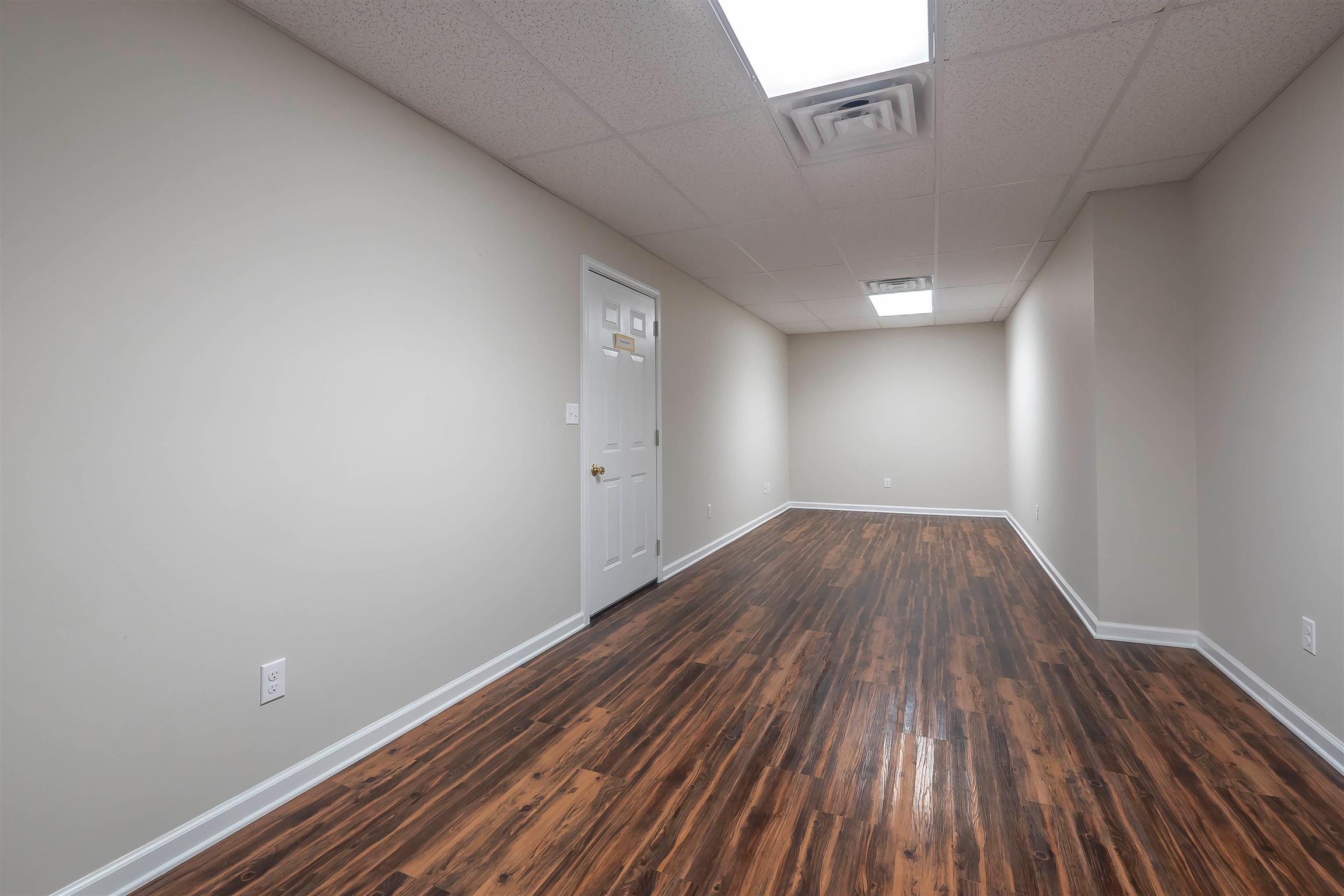 7722 Barnhill Road Primm Springs, TN 38476 - Photo 9 of 30 a view of a room with wooden floors and led lights