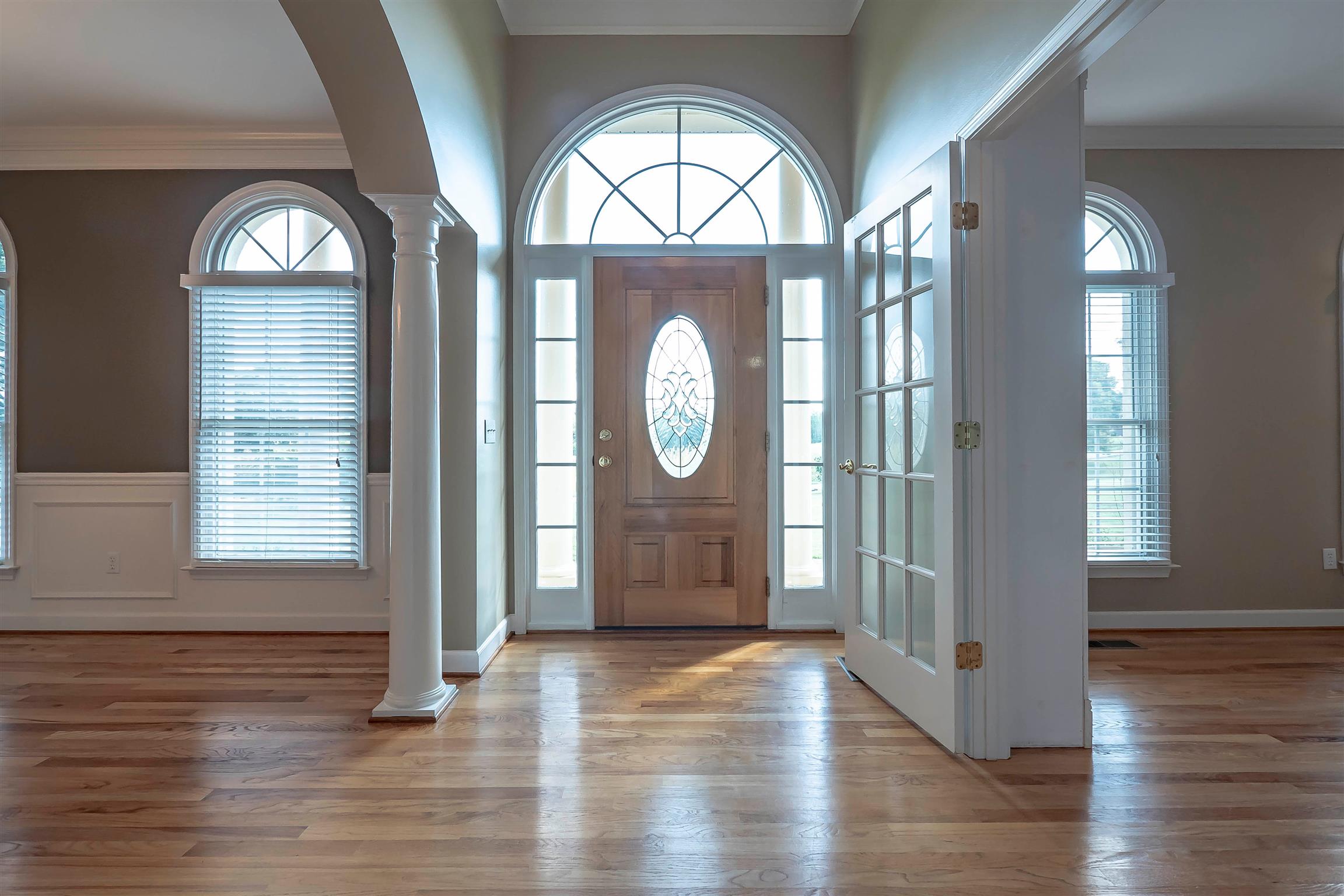 7722 Barnhill Road Primm Springs, TN 38476 - Photo 10 of 30 a view of a hallway with wooden floor clock and windows