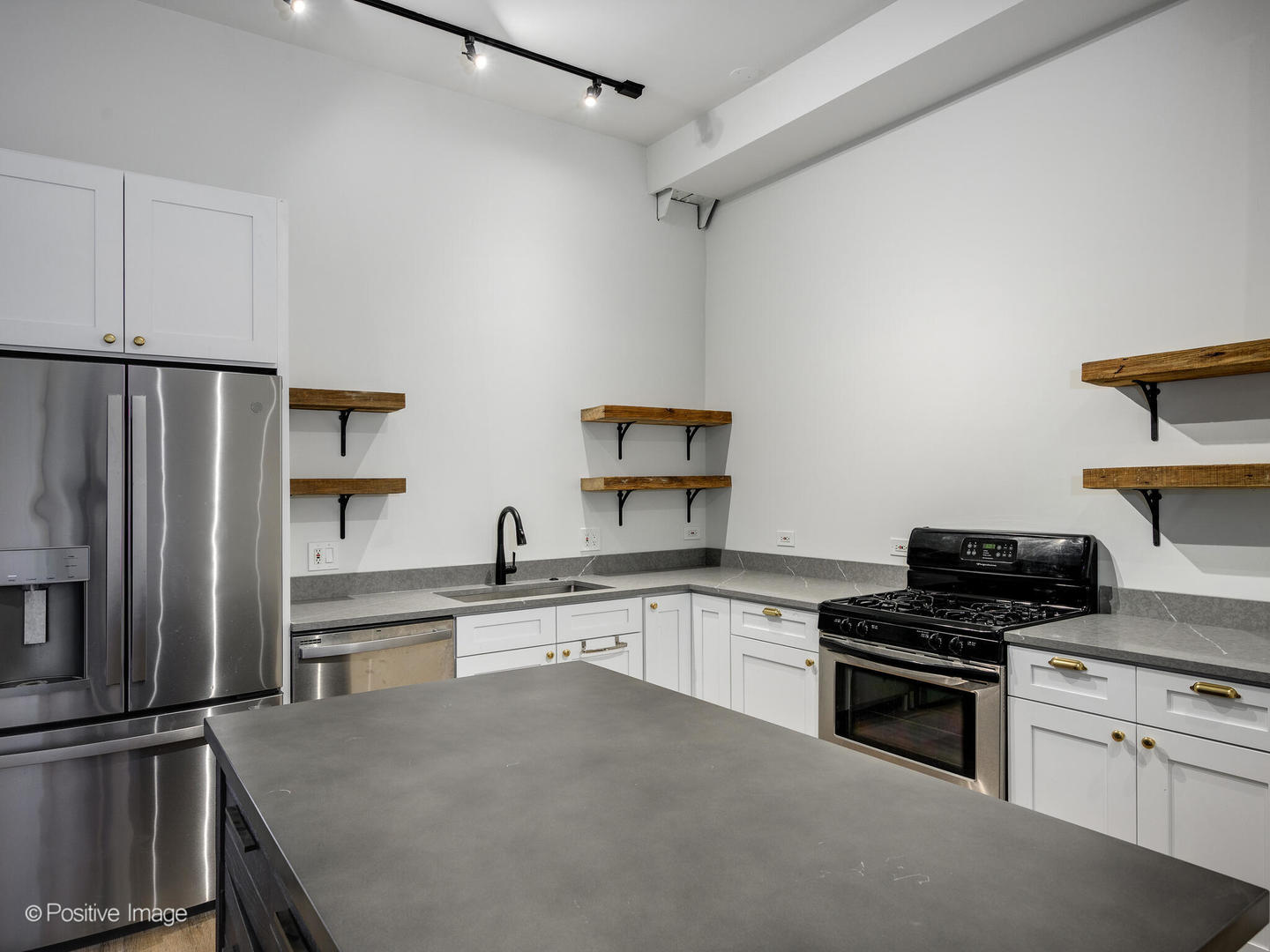 2418 West Bloomingdale Avenue, Unit 102 Chicago, IL 60647 - Photo 11 of 14 a kitchen with granite countertop a refrigerator stove and sink