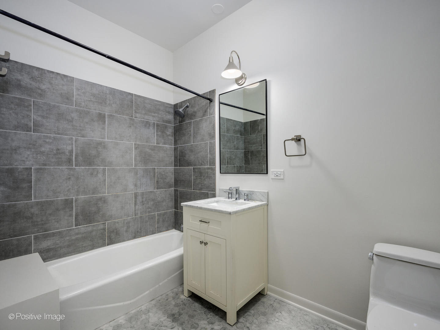 2418 West Bloomingdale Avenue, Unit 102 Chicago, IL 60647 - Photo 8 of 14 a bathroom with a sink a toilet a mirror and bathtub
