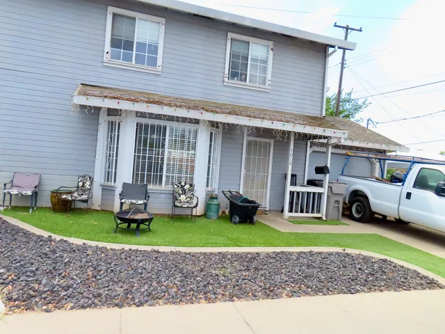 a bedroom with bed and a chandelier