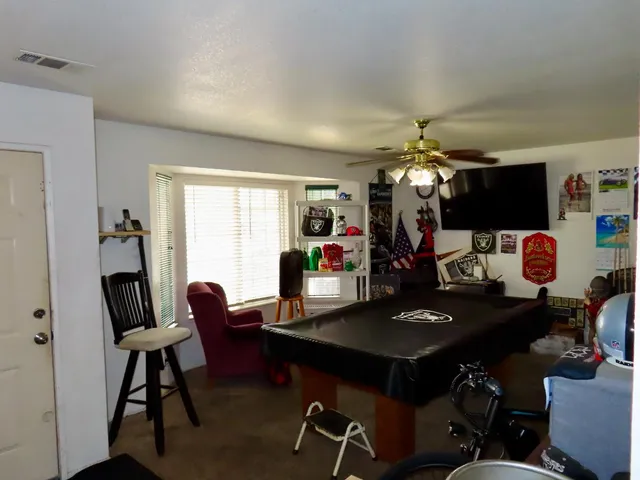 a view of a patio with table and chairs