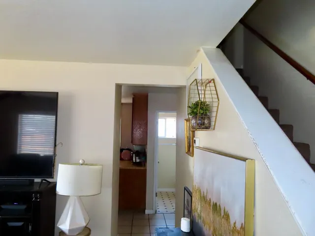 a dining room with furniture and a flat screen tv