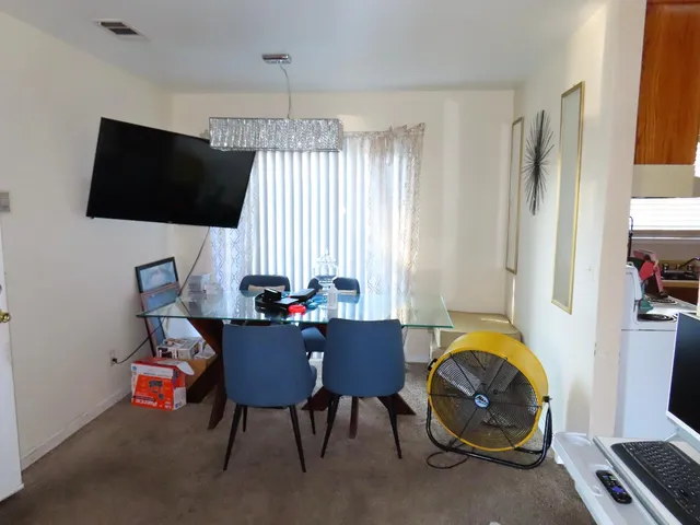 a kitchen with stainless steel appliances a stove a sink and a refrigerator with white cabinets