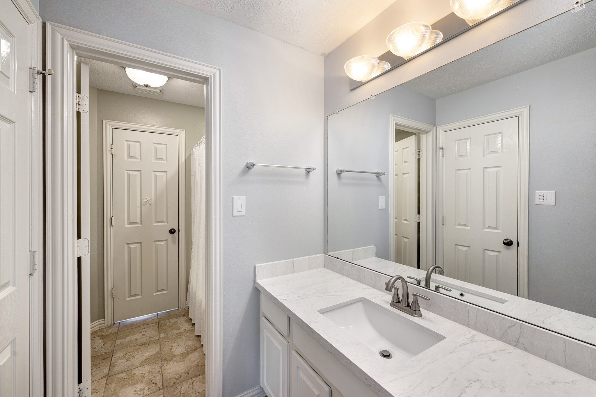 2511 Bridgestone Park Lane Spring, TX 77386 - Photo 19 of 25 A jack-and-jill bath with dual sinks topped with quartz counter, dual walk-in closets, and a tub with shower.