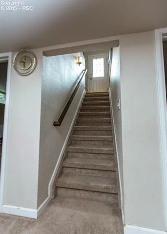 2007 North Chelton Road Colorado Springs, CO 80909 - Photo 18 of 35 Here is the carpeted stairway leading to the basement, from the kitchen area.