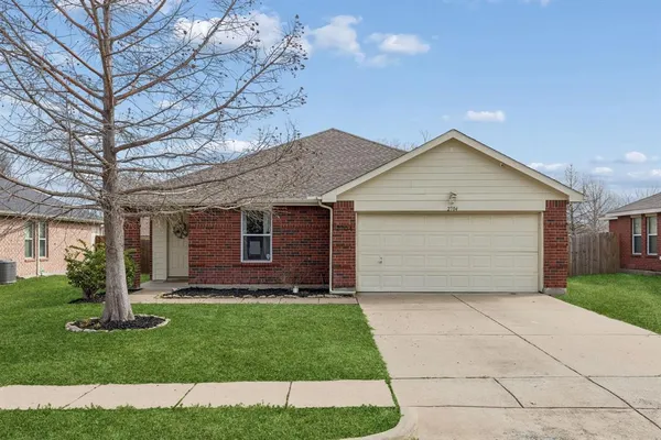a front view of a house with a garden and yard