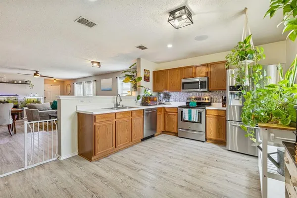 a kitchen with a sink appliances and cabinets