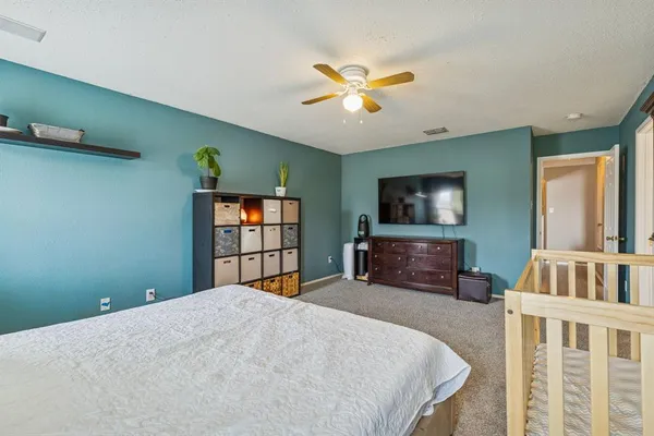 a bedroom with a bed and a flat screen tv