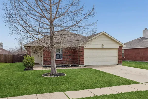 a front view of a house with a garden and yard