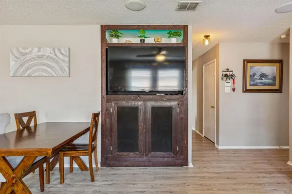 a view of a livingroom with furniture and a flat screen tv