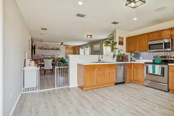 a kitchen with a sink cabinets and wooden floor