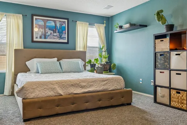 a bedroom with a bed and dresser