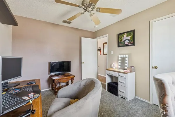 a livingroom with workspace and a window