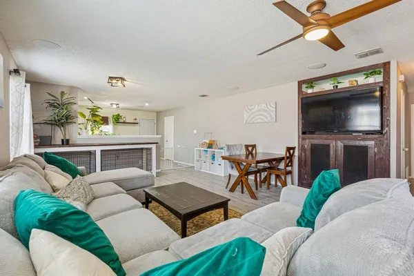a living room with furniture a fireplace and a flat screen tv
