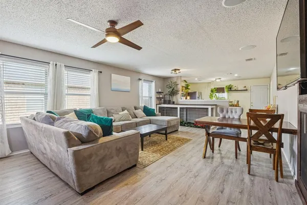 a living room with furniture wooden floor and a window