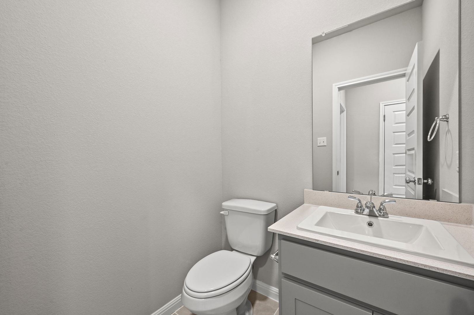 174 Hornet Street Elgin, TX 78621 - Photo 25 of 36 a bathroom with a toilet a sink and mirror