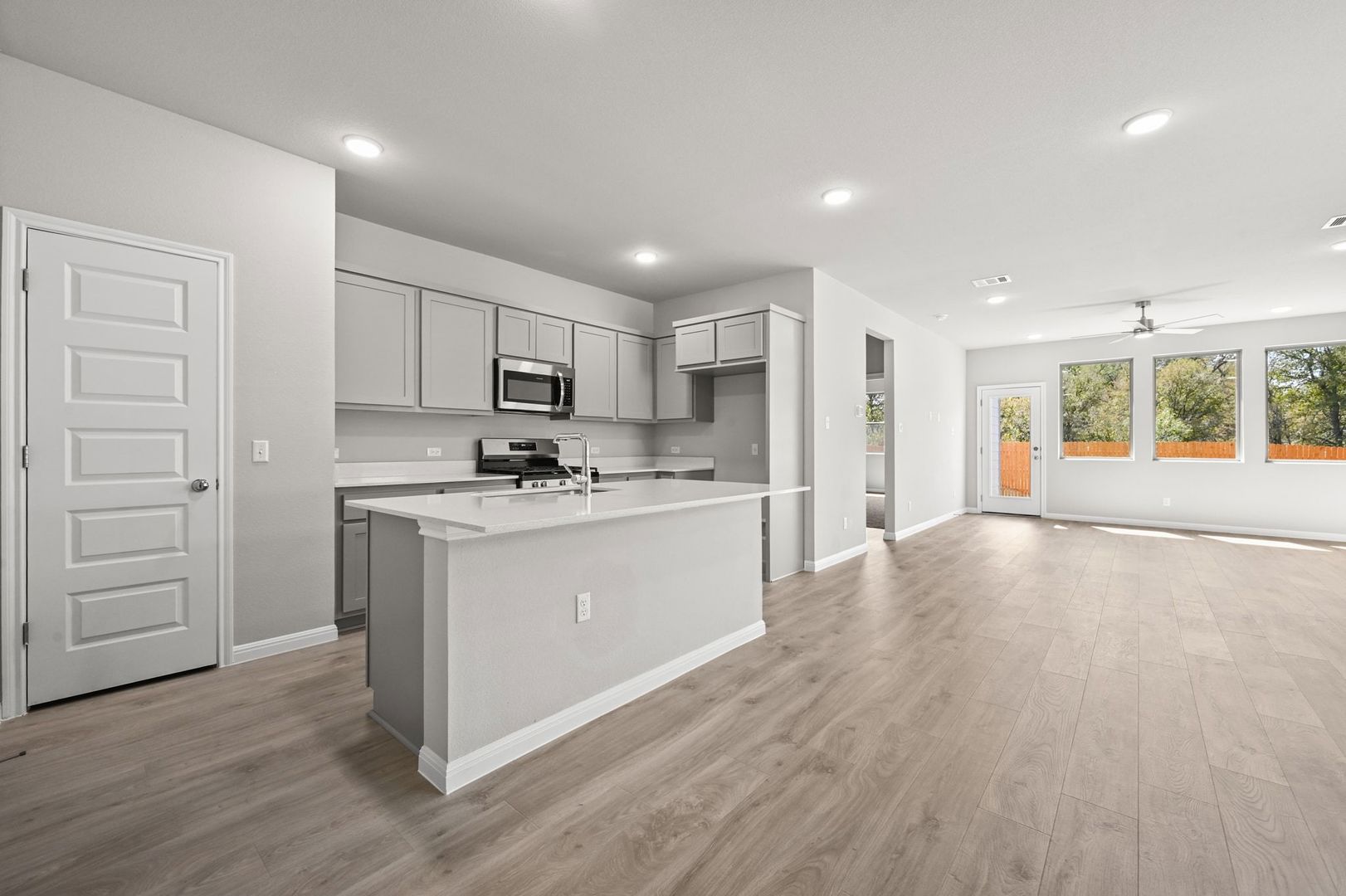 174 Hornet Street Elgin, TX 78621 - Photo 4 of 36 a kitchen with stainless steel appliances granite countertop a stove a sink and a refrigerator