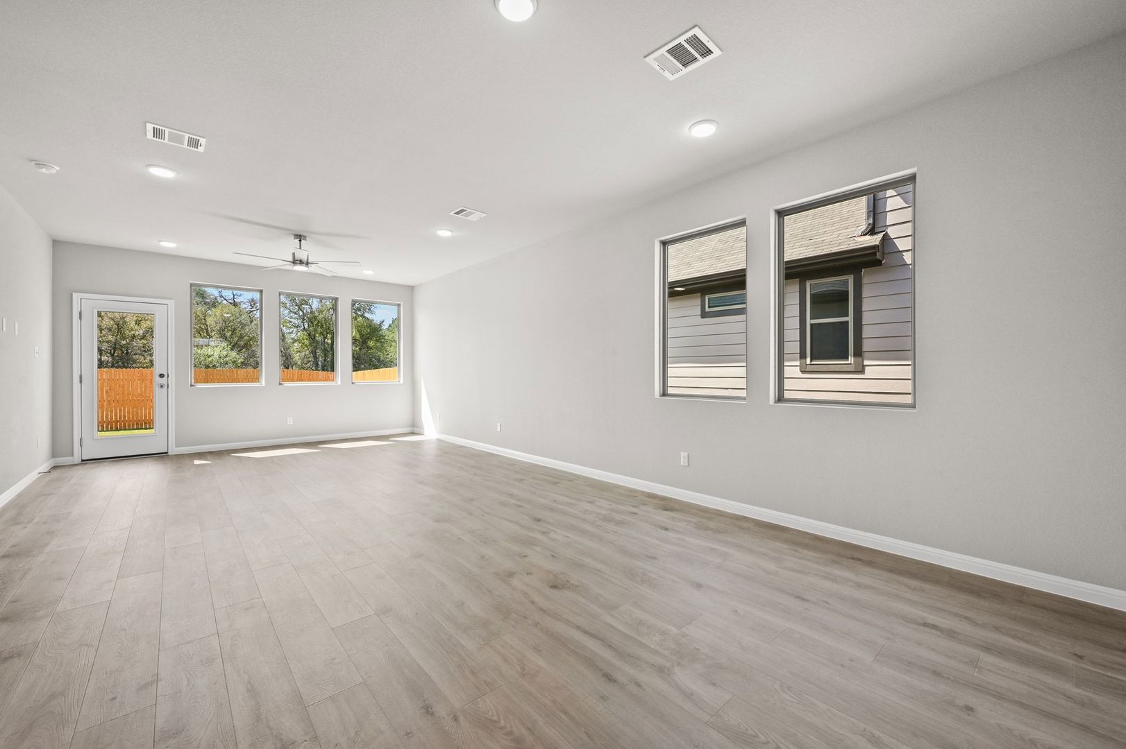 174 Hornet Street Elgin, TX 78621 - Photo 8 of 36 a view of an empty room with a window and wooden floor