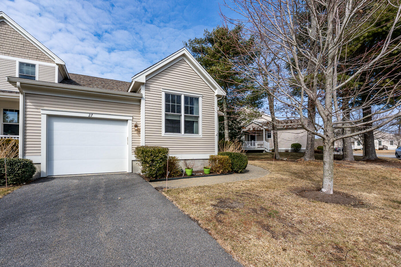 27 Grey Hawk Drive Mashpee, MA 02649 - Photo 26 of 40 a front view of a house with a yard and garage