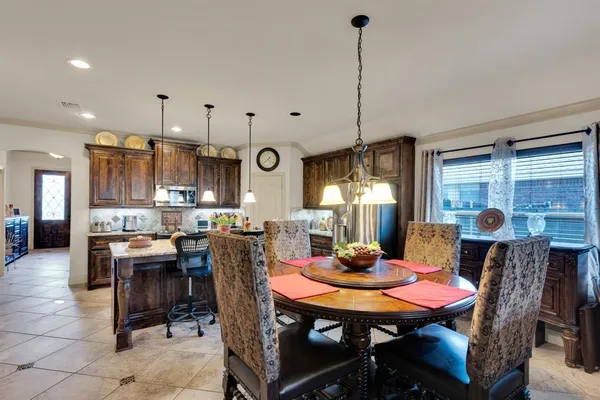 a kitchen with stainless steel appliances granite countertop a sink a stove and a wooden floors
