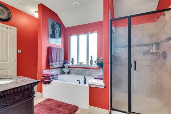 a bathroom with a tub sink and mirror