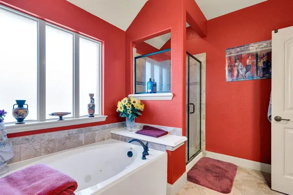 a bedroom with a bed and ceiling fan
