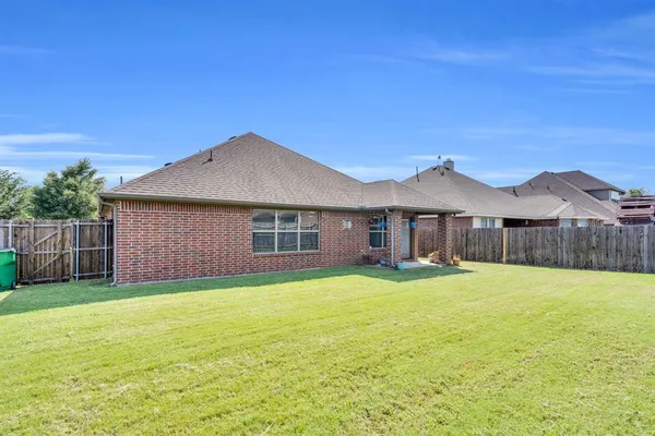 a front view of a house with yard and green space