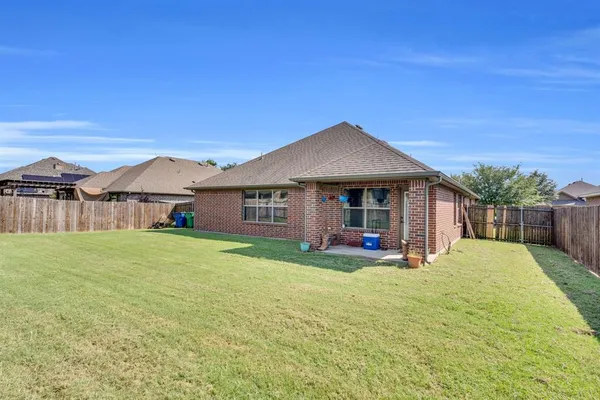a view of a house with a yard and sitting area