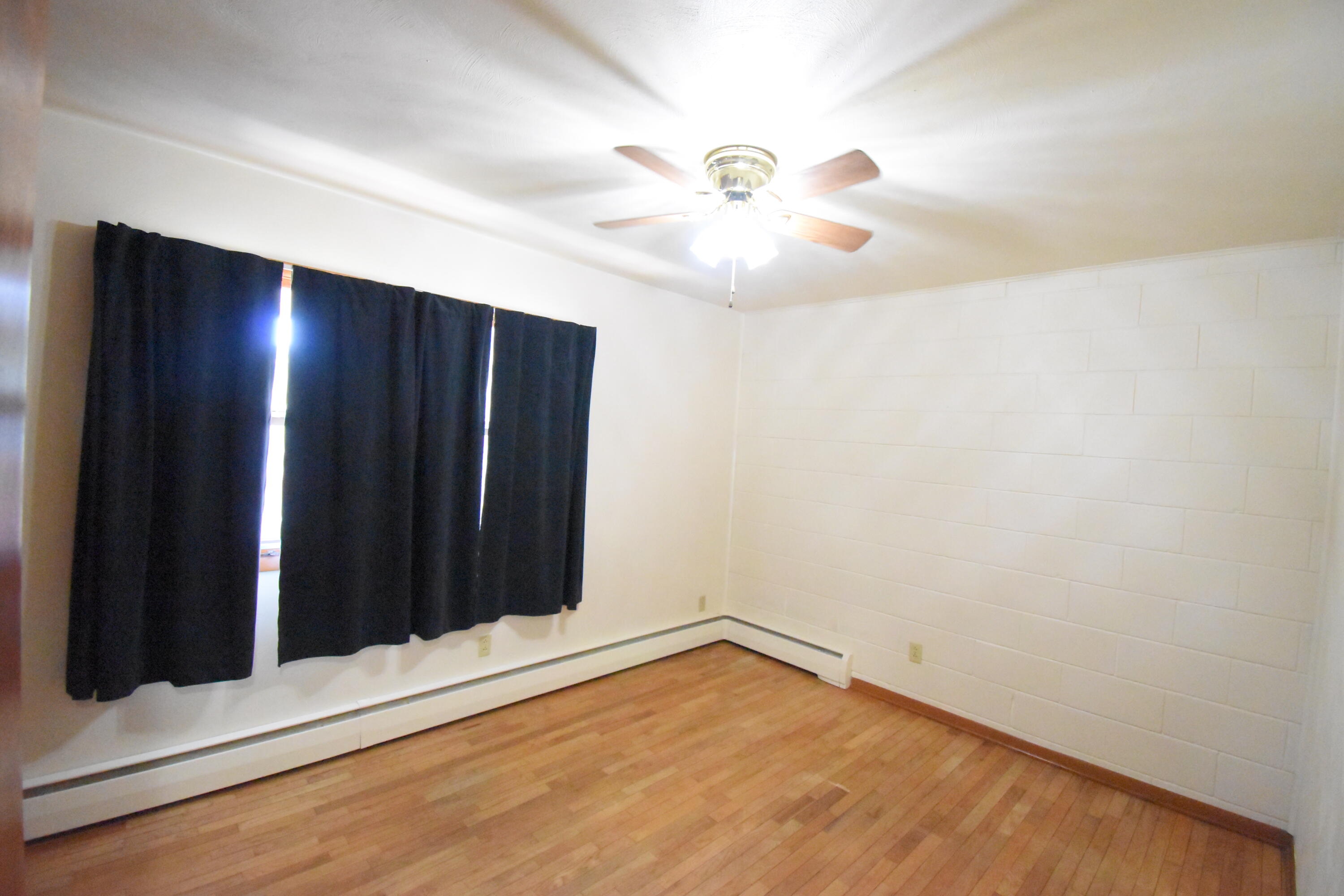981 East Washington Street Rensselaer, IN 47978 - Photo 12 of 21 an empty room with wooden floor and windows