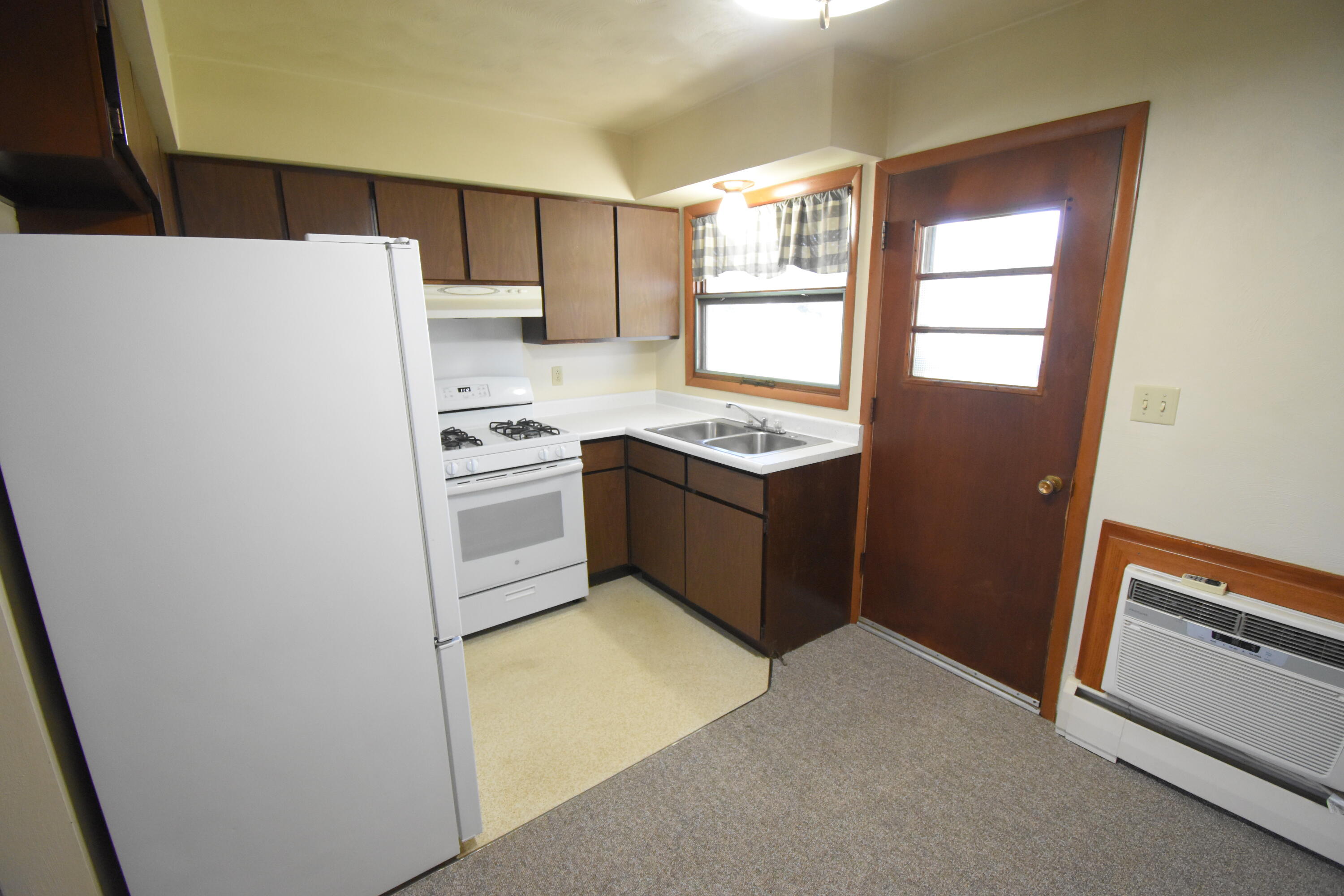 981 East Washington Street Rensselaer, IN 47978 - Photo 6 of 21 a kitchen with a refrigerator sink and cabinets